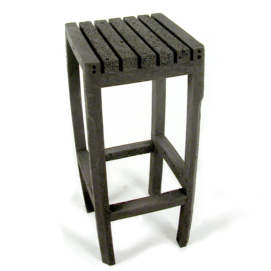 A bar-stool made from recycled barrier-posts. Because the inside of the posts is lighter and has a different tension than the outside the material bends slightly after being cut, this is what gives the stool its form. The bubbled structure inside the post is created during the production process when the plastic is injected into the mold. (recycled PET h:75 w:35 d:35 cm )

