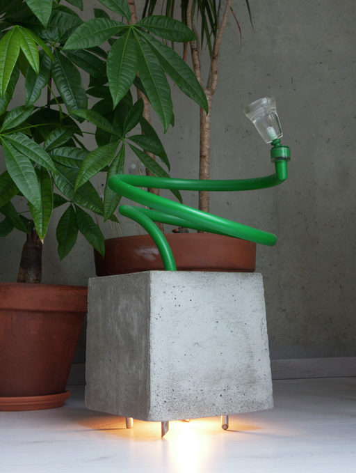 Sometimes plants can move concrete by growing under it. I wanted to make a lamp that would be able to lift a concrete block. A mood-light that makes the room not completely dark. The concrete block rises when you turn the green handle. ( steel, concrete, PMMA, h:58 w:23 d:23 cm )