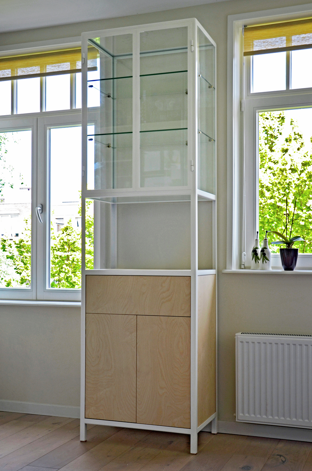 Cupboard made from metal frame, glass and birch plywood.