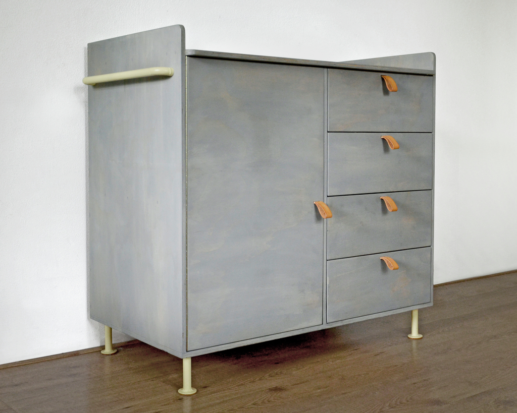 Sold as a rock. Can be used as a commode or as a working tabel. Made from plywood with metal bars and legs, and leather handles that can be opened with one finger.
